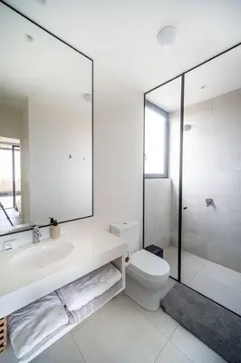 a bathroom with a sink and a toilet and a mirror at Aldea 1BR Bohemian Rooftop Ocean View for 2 in Paracas