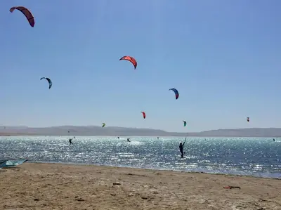 a group of people flying kites on the beach at Aldea 1BR Bohemian Rooftop Ocean View for 2 in Paracas