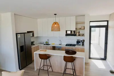 a kitchen with a white counter and a refrigerator at Aldea 2BR Boho Style for 4 with Gym, Pool and Cowork in Paracas