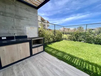a kitchen with a sink and a yard with grass at Aldea 2BR Family, Big FrontYard for 6 with Gym and Pool in Paracas