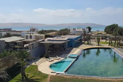 an overhead view of a swimming pool in a resort at Aldea 2BR Family, Big FrontYard for 6 with Gym and Pool in Paracas