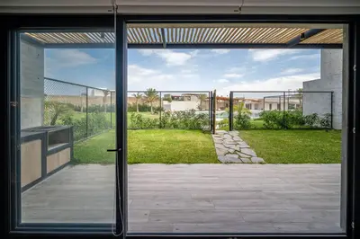 an open door with a view of a yard at Aldea 2BR Family, Big FrontYard for 6 with Gym and Pool in Paracas