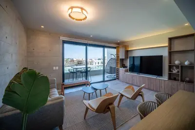 a living room with a couch and a table and chairs at Aldea 2BR TVs, KamadoBBQ for 6, Gym,Pool and Cowork in Paracas