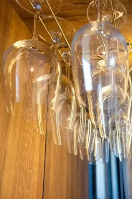 a bunch of wine glasses hanging from a chandelier at Aldea 2BR TVs, KamadoBBQ for 6, Gym,Pool and Cowork in Paracas