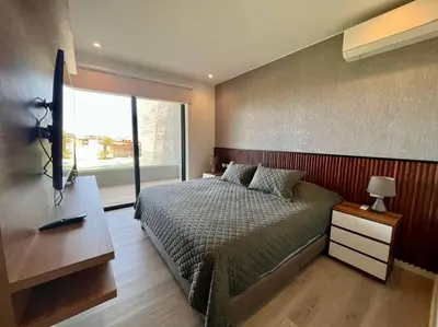 a bedroom with a bed and a large window at Aldea 2BR TVs, KamadoBBQ for 6, Gym,Pool and Cowork in Paracas