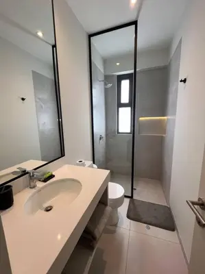 a bathroom with a sink and a toilet and a mirror at Aldea 2BR, Service Room and Ocean View for 7 in Paracas