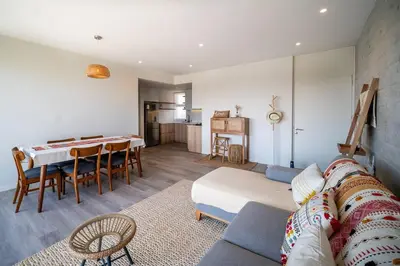 a living room with a couch and a table at Aldea 2BR Ocean View and Kamado BBQ for 6 in Paracas