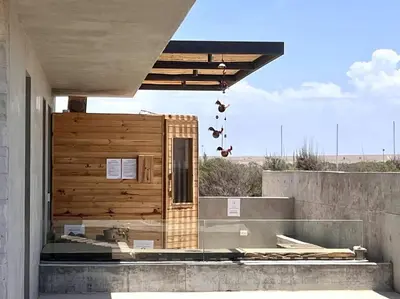 a building with a wooden wall on the outside at Aldea 2 Bedroom with Private Sauna for 4 in Paracas