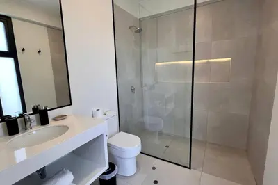 a bathroom with a shower and a toilet and a sink at Aldea 3 Bedroom Terrace Escape with Service Room in Paracas