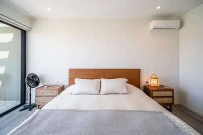 a bedroom with a large bed and a window at Aldea 1BR Romance Seascape for 2 in Paracas