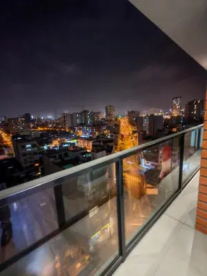 a view of a city at night from a balcony at Departamento Amoblado en Lince in Lima