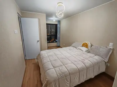 a bedroom with a large bed and a window at Departamento Amoblado en Lince in Lima