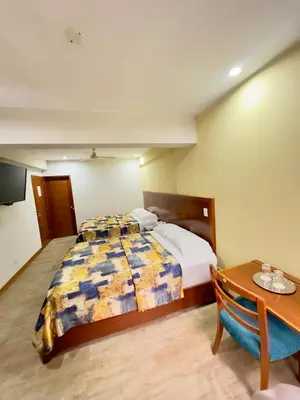 a hotel room with a bed and a table at Hotel Esencia Suites in Lima