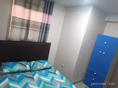 a bedroom with a bed and a blue dresser at MarsHouse in Chirimoyo