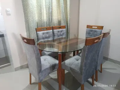 a dining room table with chairs and a glass table at MarsHouse in Chirimoyo