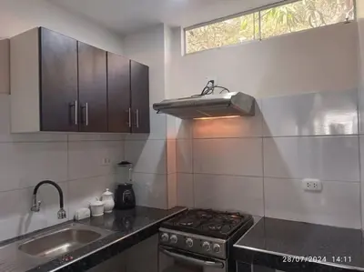 a kitchen with a stove and a sink and a window at MarsHouse in Chirimoyo