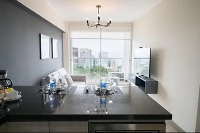 a kitchen with a black counter top in a room at Connect Apartment by Vibrant in Lima