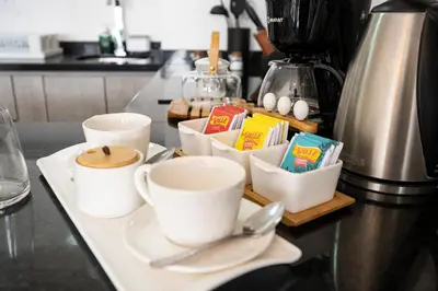 a counter with two cups and spoons on a table at Connect Apartment by Vibrant in Lima