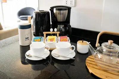 a counter with two cups and saucers on a table at Connect Apartment by Vibrant in Lima