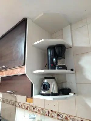 a coffeemaker sitting on a shelf in a kitchen at Apartamento acogedor en La Perla in Lima