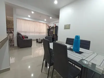 a dining table and chairs in a living room at Casa Mónaco in Cusco