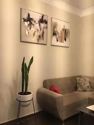 a living room with a couch and a plant at Hernandez suites Suite203 in Lima