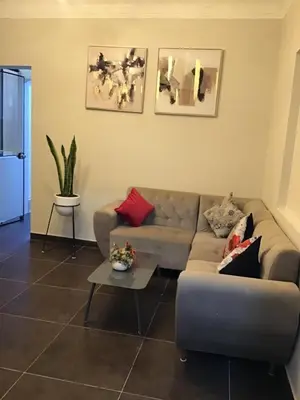 a living room with a couch and a table at Hernandez suites Suite203 in Lima