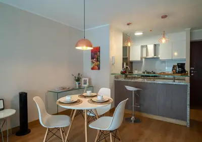 a kitchen and dining room with a table and chairs at Luxury Flat Miraflores Pool Gym Fast WiFi Balcony in Lima