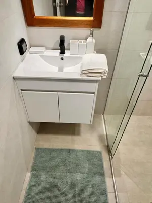 a bathroom with a white sink and a mirror at betoben in Lima