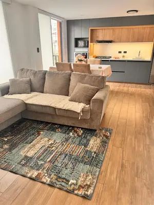 a living room with a couch and a rug at betoben in Lima