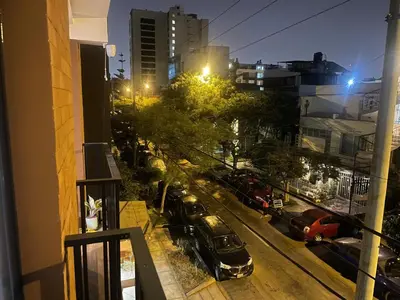 a view of a city street at night from a balcony at betoben in Lima