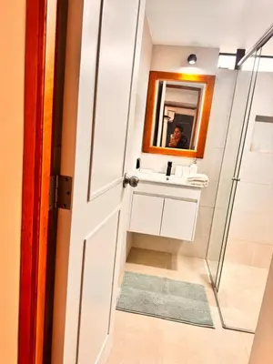 a bathroom with a sink and a mirror at betoben in Lima