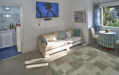 a living room with a couch and a table at B&B El Olivar in Lima