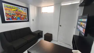 a living room with a couch and a table at Departamento centro in Andahuaylas