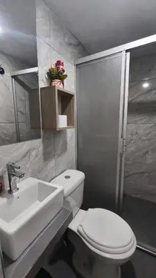a bathroom with a white toilet and a sink at Departamento centro in Andahuaylas