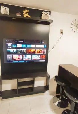a flat screen tv sitting on a stand in a room at Departamento centro in Andahuaylas