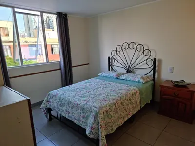 a bedroom with a bed and a window at Hermoso Departamento en Pueblo Libre in Lima