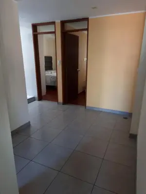 an empty room with a tiled floor and a bedroom at Hermoso Departamento en Pueblo Libre in Lima