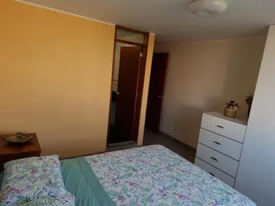 a bedroom with a bed and a dresser and a mirror at Hermoso Departamento en Pueblo Libre in Lima