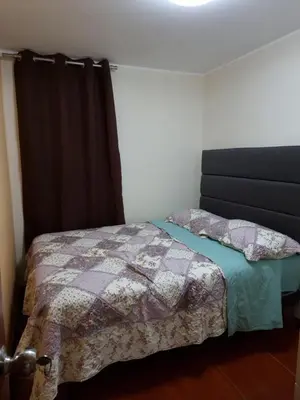 a bedroom with a bed with a quilt on it at Hermoso Departamento en Pueblo Libre in Lima