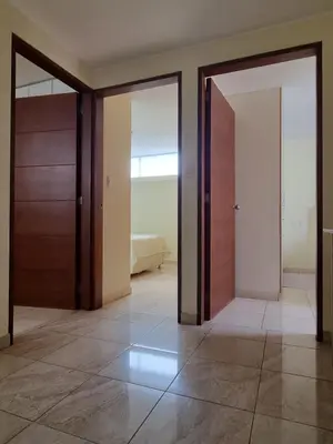 an empty room with two doors and a tiled floor at Hermoso Departamento en Pueblo Libre in Lima