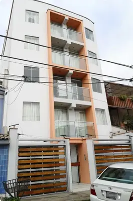 a building with a car parked in front of it at Edificio La Católica in Lima
