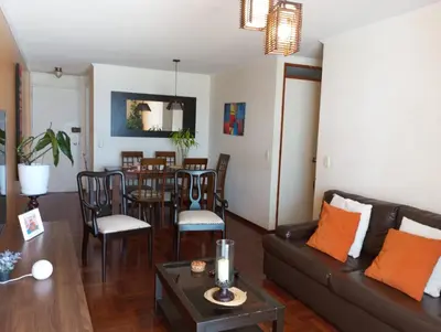 a living room with a couch and a table at Habitación con vista al mar in Lima