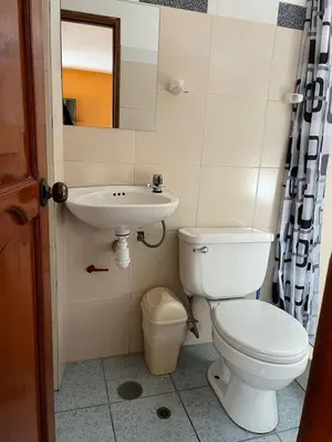 a bathroom with a toilet and a sink at Hospedaje El Centro in Ayacucho