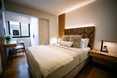 a bedroom with a large bed and a chair at Beautiful and Well Located in Lima