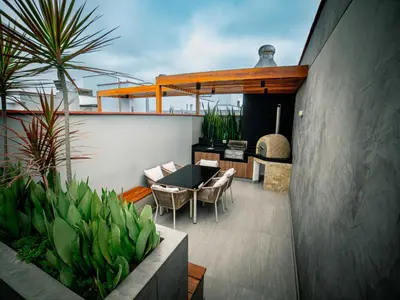 a patio with a table and chairs on a balcony at Beautiful and Well Located in Lima
