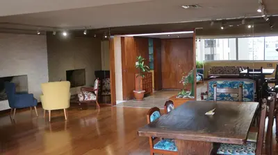 a living room with a wooden table and chairs at Penthouse in the centre of Miraflores in Lima