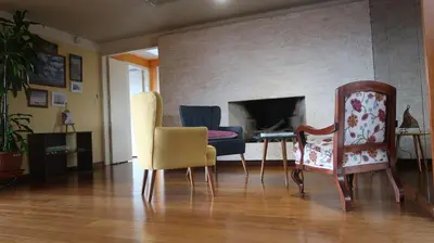a living room with chairs and a table and a fireplace at Penthouse in the centre of Miraflores in Lima