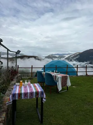 a table and chairs with a view of a mountain at Memorable Sacred Experience in Cusco