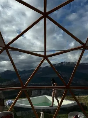 a woman is standing next to a swimming pool at Memorable Sacred Experience in Cusco